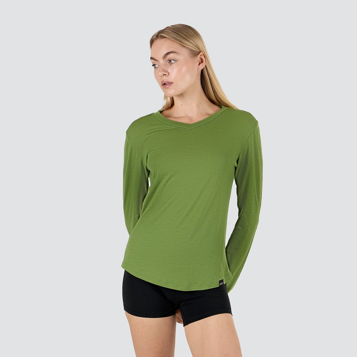 Women's ultralight merino wool long sleeve shirt in Forrest Moss, three-quarter front view